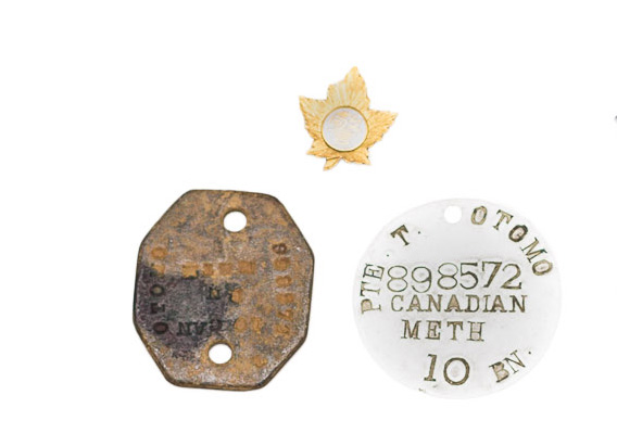 Private Toshimitsu Otomo's military identification discs, 1916. Toshimitsu Otomo collection, NNM 2016.23.1.2.1-2. Top: lapel pin, circa 1939. Toshimitsu Otomo collection, NNM 2016.23.2.1.2.